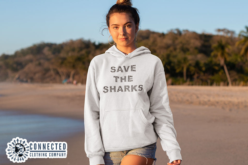 woman on the beach wearing White Save The Sharks Unisex Hoodie - sharonkornman - Ethically and Sustainably Made - 10% donated to Oceana shark conservation